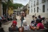A woman dances as she waits with a group to enter a charity center to eat a meal, during a blackout in Havana, Tuesday, March 17, 2026. (AP Photo/Ramon Espinosa)