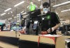 A cashier rings in purchases at a grocery store in North Vancouver on Sunday, March 22, 2020. THE CANADIAN PRESS/Jonathan Hayward