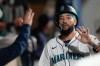 FILE - Seattle Mariners' J.P. Crawford celebrates in the dugout after scoring off a single hit by Josh Naylor during the fourth inning of a baseball game against the Colorado Rockies, Wednesday, Sept. 24, 2025, in Seattle. (AP Photo/Ryan Sun, File)