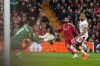 Galatasaray's goalkeeper Ugurcan Cakır, left, makes a save in front of Liverpool's Mohamed Salah, center, during the second leg of the Champions League round of 16 soccer match between Liverpool and Galatasaray, in Liverpool, England, Wednesday, March 18, 2026. (AP Photo/Jon Super)