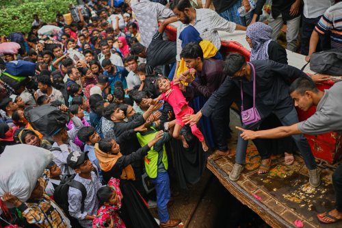 Thousands of travelers scramble and jostle each other to board ferries at the Sadarghat Launch Terminal, joining the massive annual exodus to celebrate Eid al-Fitr in their hometowns, in Dhaka, Bangladesh, Wednesday, March 18, 2026. (AP Photo/Mahmud Hossain Opu)