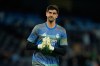 Real Madrid's goalkeeper Thibaut Courtois enters the pitch to warm up for the Champions League round of 16 second leg soccer match between Manchester City and Real Madrid in Manchester, Tuesday, March 17, 2026. (AP Photo/Dave Thompson)