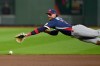 United States shortstop Bobby Witt Jr. (7) dives for a hit by Canada outfielder Tyler O'Neill (9) during the first inning of a World Baseball Classic quarterfinal game, Friday, March 13, 2026, in Houston. (AP Photo/David J. Phillip)