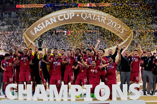 FILE - The Qatar team poses with the trophy at the end of the Asian Cup final soccer match between Qatar and Jordan at the Lusail Stadium in Lusail, Qatar, Feb. 10, 2024. (AP Photo/Thanassis Stavrakis, File)