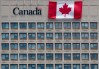 A giant Canadian flag hangs on the side of a government office building in downtown Ottawa on Tuesday, June 30, 2020. THE CANADIAN PRESS/Adrian Wyld