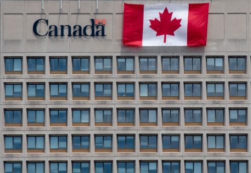 A giant Canadian flag hangs on the side of a government office building in downtown Ottawa on Tuesday, June 30, 2020. THE CANADIAN PRESS/Adrian Wyld