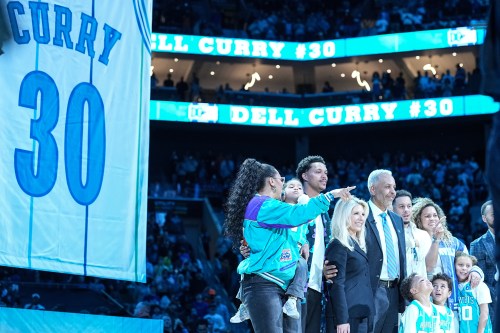 Former Charlotte Hornets player Dell Curry, fifth from left, poses alongside family at halftime as his jersey is retired during an NBA basketball game against the Orlando Magic, Thursday, March 19, 2026, in Charlotte, N.C. (AP Photo/Matt Kelley)
