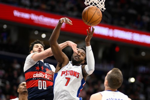 Detroit Pistons forward Paul Reed (7) and Washington Wizards forward Tristan Vukcevic (00) battle for the ball during the first half of an NBA basketball game, Thursday, March 19, 2026, in Washington. (AP Photo/Nick Wass)