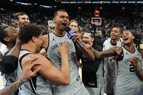 San Antonio Spurs forward Victor Wembanyama, center, celebrates with teammates after he hit a game-winning score against the Phoenix Suns in the final seconds of an NBA basketball game in San Antonio, Thursday, March 19, 2026. (AP Photo/Eric Gay)