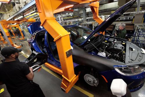 FILE - In this March 14, 2014, file photo, an assembly line worker builds a 2015 Chrysler 200 automobile at the Sterling Heights Assembly Plant in Sterling Heights, Mich. Fiat (AP Photo/Paul Sancya, File)