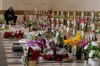 A man prays over the graves of Hezbollah fighters killed, at Al-Hawraa Zaynab Cemetery during Eid al-Fitr in Dahiyeh, Beirut's southern suburbs, Lebanon, Friday, March 20, 2026. (AP Photo/Hassan Ammar)