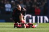 Liverpool's Hugo Ekitike is helped during the English Premier League soccer match between Brighton and Liverpool in Brighton, Saturday, March 21, 2026. (AP Photo/Ian Walton)