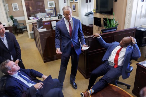 Senate Majority Leader John Thune R-S.D., center, privately speaks to Sen. Jon Husted, R-Ohio, and Sen. Tim Scott, R-S.C., ahead of a news conference on Capitol Hill on Saturday, March 21, 2026, in Washington. (AP Photo/Tom Brenner)