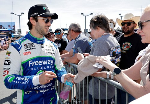 Daniel Suarez (7) signs an autograph for a fan before a NASCAR Cup Series auto race at Las Vegas Motor Speedway Sunday, March 15, 2026, in Las Vegas. (AP Photo/Steve Marcus)