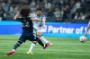San Jose Earthquakes' Beau Leroux, back, kicks the ball, to score, as Vancouver Whitecaps' Aziel Jackson (22) defends during the first half of an MLS soccer match in Vancouver, on Saturday, March 21, 2026. THE CANADIAN PRESS/Ethan Cairns