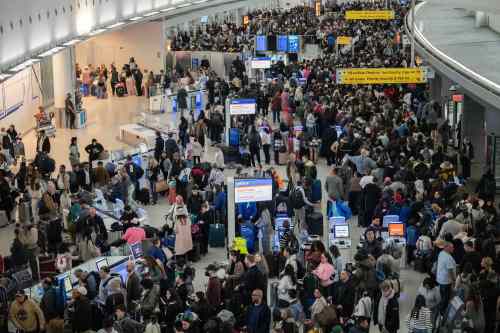 People wait in a TSA line at the John F. Kennedy International Airport, Sunday, March 22, 2026, in New York. (AP Photo/Yuki Iwamura)