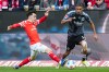 Mainz' Paul Nebel, left, and Frankfurt's Jean-Matteo Bahoya, right, challenge for the ball during the German Bundesliga soccer match between 1.FSV Mainz 05 and Eintracht Frankfurt in Mainz, Germany, Sunday, March 22, 2026. (Marc Schueler/dpa via AP)