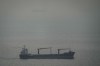 A cargo ship carrying vehicles sails through the Arabian Gulf toward the Strait of Hormuz in the United Arab Emirates, Sunday, March 22, 2026. (AP Photo)