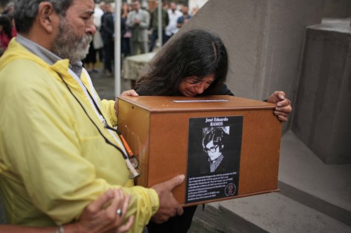 Ana Ramos cries as she holds the remains of her brother Jose Eduardo Ramos, who along with his wife Alicia Dora Cerrota was kidnapped and disappeared by the Argentine dictatorship in 1976, at the cemetery for burial in Tafi Viejo, Thursday, March 5, 2026.(AP Photo/Victor R. Caivano)