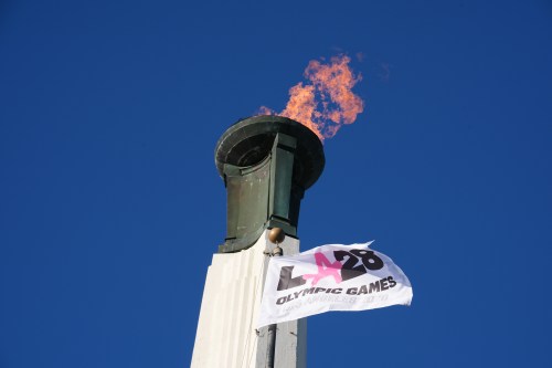 FILE - The Olympic cauldron is lit at the Los Angeles Memorial Coliseum ahead of the launch for ticket registration to the 2028 Summer Olympic Games, Jan. 13, 2026, in Los Angeles. (AP Photo/Damian Dovarganes, File)