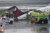 Firefighters and investigators examine the site, Monday, March 23, 2026, where an Air Canada jet came to rest after colliding with a Port Authority firetruck at LaGuardia Airport, after landing Sunday night in New York. (AP Photo/Seth Wenig)