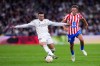 Real Madrid's Kylian Mbappe, left, and Atletico Madrid's Marcos Llorente challenge for the ball during the Spanish La Liga soccer match between Real Madrid and Atletico Madrid in Madrid, Spain, Sunday, March 22, 2026. (AP Photo/Manu Fernandez)