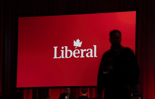 File photo — A photographer walks through the room ahead of the Liberal leadership announcement, Sunday, March 9, 2025 in Ottawa.  THE CANADIAN PRESS/Adrian Wyld