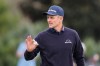 Justin Rose of England acknowledges applause after his putt on the 11th green during the second round of The Players Championship golf tournament Friday, March 13, 2026, in Ponte Vedra Beach, Fla. (AP Photo/Gerald Herbert)