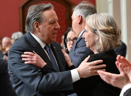 Quebec Health and Social Services Minister Sonia Bélanger is congratulated by Premier François Legault after tabling Bill 23 at the National Assembly March 24, 2026. THE CANADIAN PRESS/Jacques Boissinot