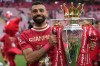 FILE - Liverpool's Mohamed Salah poses with the winner's trophy after the English Premier League soccer match between Liverpool and Crystal Palace at the Anfield stadium in Liverpool, England, May 25, 2025. (AP Photo/Jon Super, File)