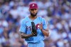 FILE - Philadelphia Phillies starting pitcher Cristopher Sanchez claps as he walks off the field after a ground out by Los Angeles Dodgers' Andy Pages during the fifth inning in Game 4 of baseball's National League Division Series, Oct. 9, 2025, in Los Angeles. (AP Photo/Mark J. Terrill, File)