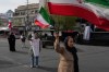 People wave Iranian flags during a campaign in support of the government at the Enqelab-e-Eslami, or Islamic Revolution, square in downtown Tehran, Iran, Sunday, March 22, 2026. (AP Photo/Vahid Salemi)