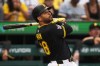 FILE - Pittsburgh Pirates' Tommy Pham follows through on a double off Los Angeles Dodgers pitcher Clayton Kershaw, driving in two runs, during the first inning of a baseball game in Pittsburgh, Sept. 2, 2025. (AP Photo/Gene J. Puskar, File)