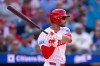 Philadelphia Phillies' Justin Crawford hits a single for his first major league at bat during the second inning of an opening-day baseball game against the Texas Rangers, Thursday, March 26, 2026, in Philadelphia. (AP Photo/Chris Szagola)