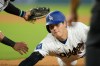 Los Angeles Dodgers designated hitter Shohei Ohtani slides safely into first base after a pickoff attempt against the Arizona Diamondbacks during the seventh inning of an opening-day baseball game Thursday, March 26, 2026, in Los Angeles. (AP Photo/Mark J. Terrill)