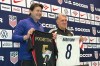 Unites States coach Mauricio Pochettino and Atlanta United coach Tara Martino pose with jerseys during a news conference before the men's national soccer team training, Friday, March 27, 2026, in Marietta, Ga. (AP Photo/Ronald Blum