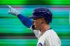 Chicago Cubs' Pete Crow-Armstrong (4) points to the dugout after bunting a one-run single during the seventh inning of an opening-day baseball game against the Washington Nationals, Thursday, March 26, 2026, in Chicago. (AP Photo/Erin Hooley)
