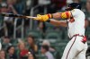 Atlanta Braves' Mauricio Dubón (14) hits a two-RBI triple against the Kansas City Royals during the seventh inning of an opening-day baseball game, Friday, March 27, 2026, in Atlanta. (AP Photo/Mike Stewart)