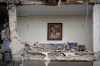 FILE - Rubble covers the furniture of a destroyed living room in a residential building hit in an earlier U.S.-Israeli strike in Tehran, Iran, March 23, 2026. (AP Photo/Vahid Salemi, File)