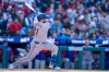 Texas Rangers' Jake Burger hits a two-run home run during the third inning of a baseball game against the Philadelphia Phillies, Saturday, March 28, 2026, in Philadelphia. (AP Photo/Chris Szagola)