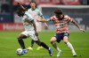 Belgium's Jeremy Doku (11) dribbles against the United States' Christian Pulisic (10) during the first half of an international friendly soccer match, Saturday, March 28, 2026, in Atlanta. (AP Photo/Mike Stewart)