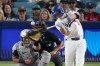 Los Angeles Dodgers' Will Smith, right, hits a two-run home run as Arizona Diamondbacks catcher James McCann watches during the eighth inning of a baseball game Saturday, March 28, 2026, in Los Angeles. (AP Photo/Mark J. Terrill)