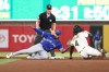 Athletics' Lawrence Butler (4) is tagged out stealing second base by Toronto Blue Jays second baseman Leo Jiménez, left, during the fifth inning of a baseball game Saturday, July 12, 2025, in West Sacramento, Calif. (AP Photo/Sara Nevis)