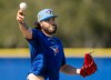 Toronto Blue Jays pitcher Cody Ponce makes a throw to first base during a drill at Spring Training in Dunedin, Fla., on Monday, Feb. 16, 2026. THE CANADIAN PRESS/Frank Gunn