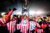 Atletico Ottawa's Ballou Tabla (13) raises the North Star Cup following Atletico Ottawa’s victory over Cavalry FC in extra time during the Canadian Premier League finals soccer action in Ottawa, on Sunday, Nov. 9, 2025. THE CANADIAN PRESS/Spencer Colby