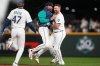 Seattle Mariners' Luke Raley celebrates with Cal Raleigh, right, after Raleigh's game-winning single against the New York Yankees after a baseball game, Monday, March 30, 2026, in Seattle. (AP Photo/Lindsey Wasson)