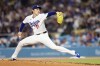 Los Angeles Dodgers starting pitcher Roki Sasaki (11) releases a pitch during the second inning of a baseball game against the Cleveland Guardians, Monday, March 30, 2026, in Los Angeles. (AP Photo/Caroline Brehman)