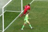 Canada's Jonathan David gathers the ball to restart the game after scoring first goal from the penalty spot as Iceland's goalkeeper from Elias Rafn Olafsson looks on during second half International friendly action, in Toronto, on Saturday March 28, 2026. THE CANADIAN PRESS/Chris Young