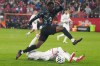 Canadian striker Tani Oluwaseyi (12) leaps over a challenge from Tunisian defender Omar Rekik in Toronto on Tuesday, March 31, 2026. THE CANADIAN PRESS/Chris Young