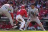 Boston Red Sox catcher Carlos Narváez, right, looks on as Cincinnati Reds' Matt McLain, center, scores as Boston Red Sox pitcher Sonny Gray, left, fields the ball in the first inning of a baseball game in Cincinnati, Saturday, March 28, 2026. (AP Photo/Carolyn Kaster)